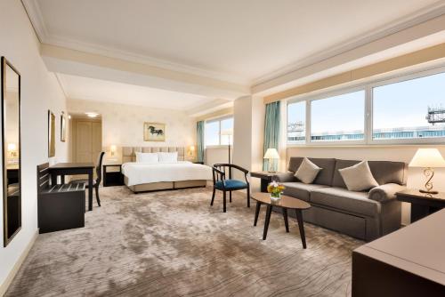 a hotel room with a bed and a couch at Wyndham Tashkent in Tashkent