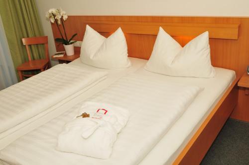 a hotel room with a bed with white towels on it at ...mein Graml in Bad Füssing