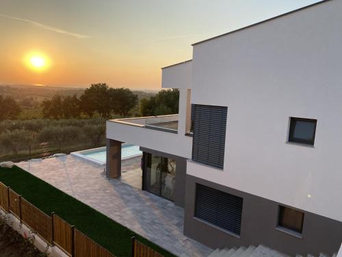 a house with a view of the sunset at Villa Boiky - private pool and amazing sea view, Istria in Materada