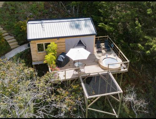 an aerial view of a tiny house with a deck at Bleu Hills Glamping Llanogrande in Rionegro