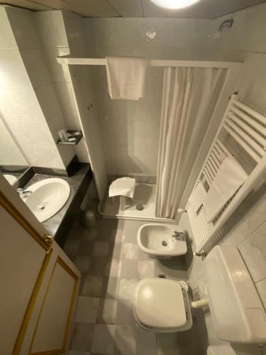 a bathroom with two toilets and a sink and a shower at Artua'&Solferino in Turin
