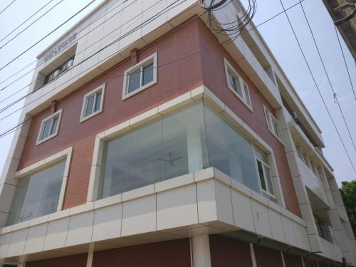 a building with a large window on the side of it at The Grand Inn in Kanjikode