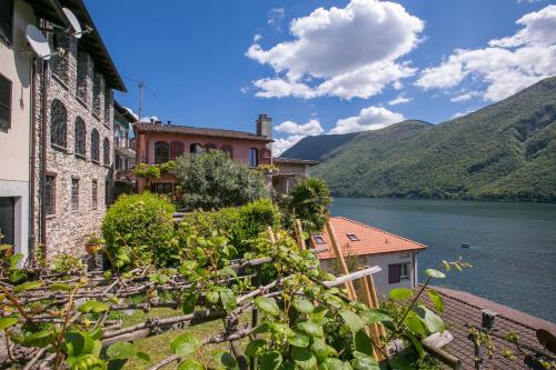 a view of a lake and buildings and a building at Magic Gandria - Happy Rentals in Lugano