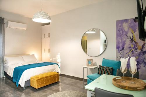 a bedroom with a bed and a table and a mirror at Modern&Quiet place in Eilat