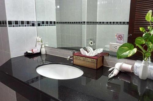 a bathroom with a sink and a mirror at Vivi Boutique Room Hotel SHA Plus in Rawai Beach