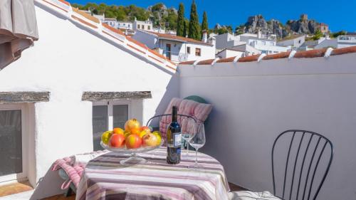 a table with a bowl of fruit on a balcony at Casa La Tinaja de Gaucin by Ruralidays in Gaucín