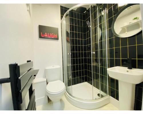 a bathroom with a toilet and a sink at Townhouse PLUS @ Lower Beth Street Stoke in Etruria