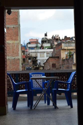 a blue bench with a view of a city at Apartment in Nepal in Kathmandu