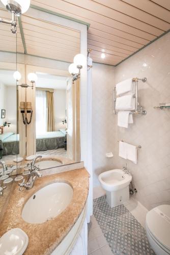 a bathroom with a sink and a toilet at Roccamare Resort - Hotel Casa di Levante in Castiglione della Pescaia