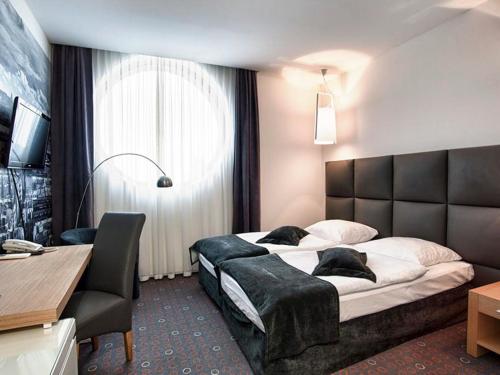 Aroma Stone Hotel Spa tesisinde bir odada yatak veya yataklar