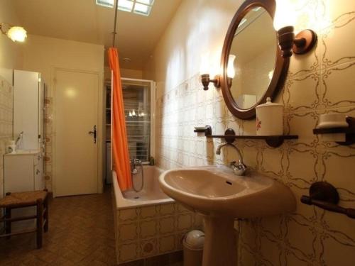 a bathroom with a sink and a mirror and a tub at Ferme du XIXe avec cheminée, près des gorges du Doulon - FR-1-582-227 in Frugières-le-Pin