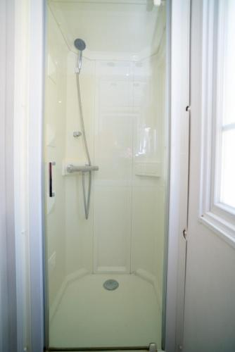 a shower with a glass door in a bathroom at Camping Joncar Mar in Roses