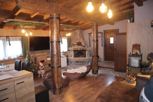 a large living room with a fireplace and wooden floors at Roots Apartment in Borovets