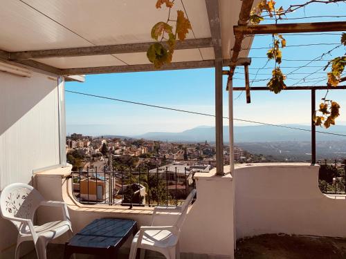 a balcony with chairs and a view of a city at מיאר אירוח דרוזי in Maghār