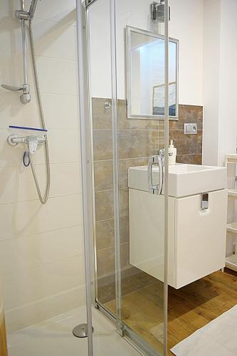 a bathroom with a shower and a sink at ForRest Apartment Krynica in Krynica Zdrój