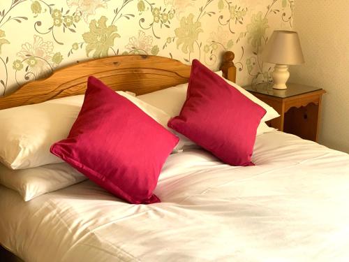 A bed or beds in a room at Carlton Lodge 