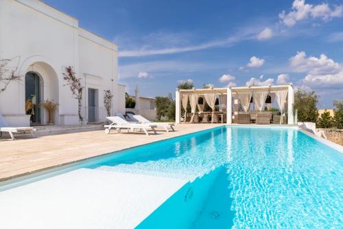 a villa with a swimming pool and a patio at Masseria Limonaia & Spa in Fasano