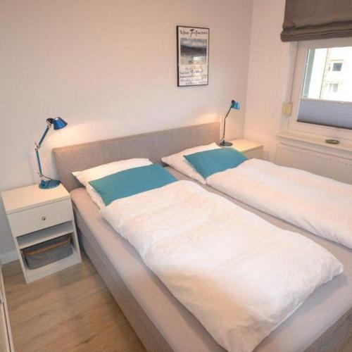two beds in a room with two lamps on them at Appartement-44 in Westerland