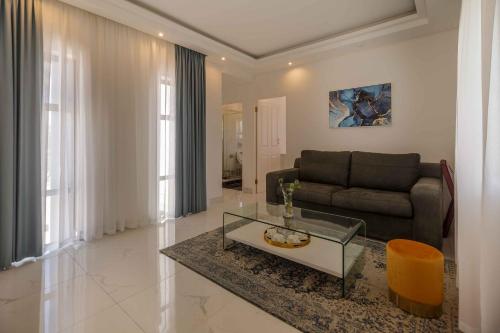 a living room with a couch and a table at Oceanway Boutique Hotel/Conference in Cape Town