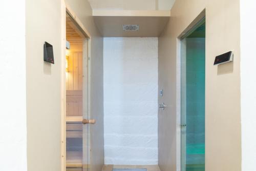 a glass door leading into a hallway with a door at Masseria Limonaia & Spa in Fasano