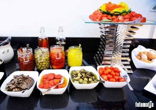 a table topped with bowls of vegetables and other foods at Aroma Stone Hotel Spa in Syców