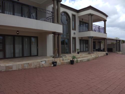 a large building with a brick driveway in front of it at Winchester Place in Port Elizabeth