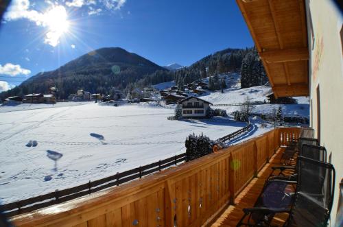 a balcony with a view of a snow covered mountain at Hotel Starjet in Flachau