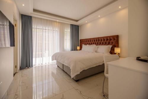 a bedroom with a bed and a large window at Oceanway Boutique Hotel/Conference in Cape Town