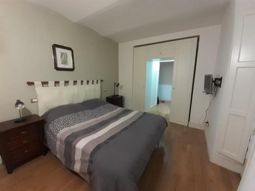 a bedroom with a bed and a door to a hallway at appartamento in centro in Roccaraso