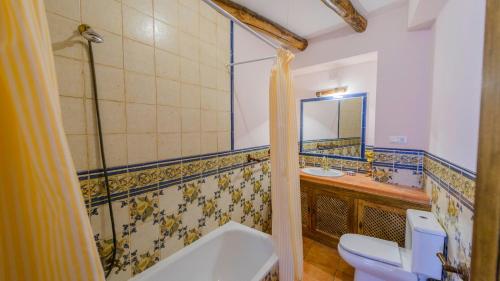 a bathroom with a sink and a toilet and a mirror at Casa El Limon Gaucin by Ruralidays in Gaucín