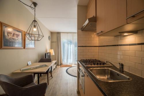a kitchen with a sink and a counter top at Buitenplaats De Mechelerhof in Mechelen