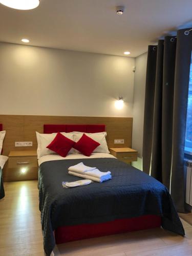 a bedroom with a bed with two towels on it at Partner Guest House in Kyiv