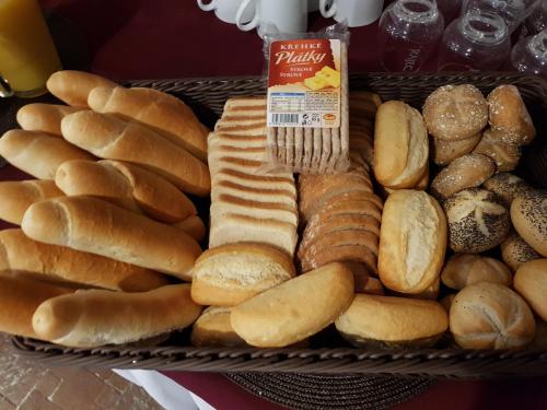 a basket of bread and pastries on a table at Pension U Krbu in Mikulov v Krušných Horách