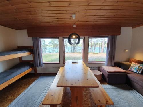 a living room with a table and bunk beds at Camping Hossan Lumo in Hossa