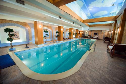 a large swimming pool in a hotel room at Ambassador in Saint Petersburg