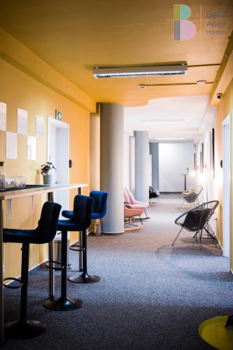 an empty waiting room with chairs and tables at Bello ApartHostel Private Rooms in Warsaw