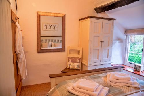 a bathroom with a table with towels on it at Finest Retreats - Little Haven in Minehead