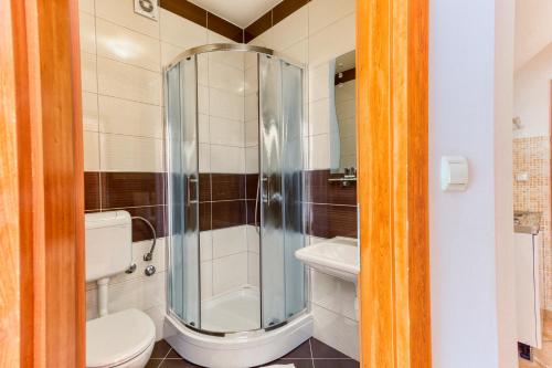 a bathroom with a shower and a toilet at Stipe Residence in Podstrana