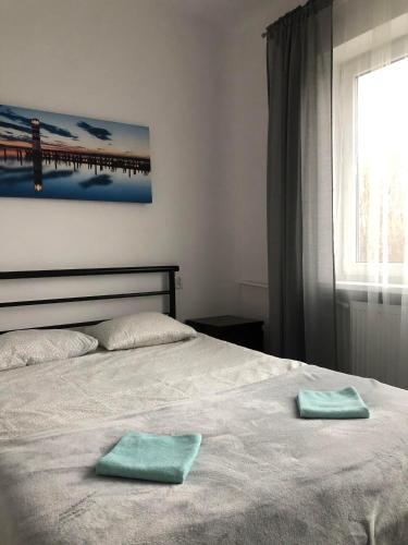 a bedroom with a bed with two towels on it at Noclegi Jachtklub Elbląg in Elblag