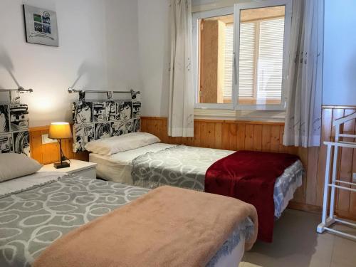 a room with two beds and a window at Sunny Escape by the Sea & Yacht Club in Altea