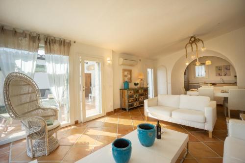 a living room with a couch and a table at BGItalianVacation - Ville Li Conchi in Castiadas
