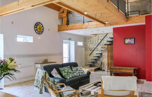 a living room with a black couch and a red wall at 2 Bedroom Cozy Home In La Meauffe in La Meauffe