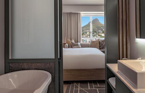 a bathroom with a bed and a tub and a sink at Hyatt Regency Cape Town in Cape Town