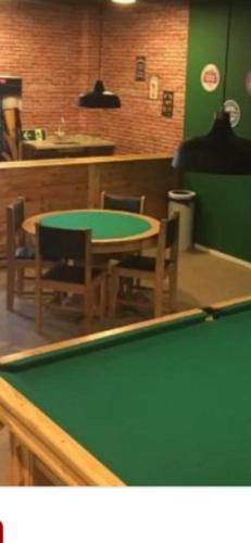 a ping pong table in a restaurant with a pool table at Loft Reserva do Sahy - Mangaratiba in Mangaratiba