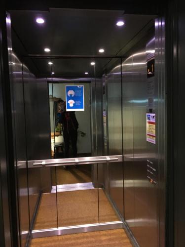 a person taking a picture of an elevator in a building at Hotel Garni in Warth am Arlberg