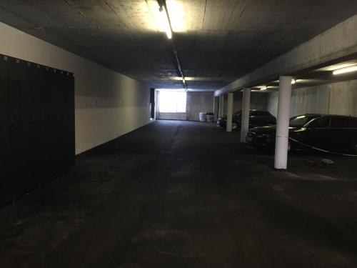 an empty parking garage with cars parked in it at Hotel Garni in Warth am Arlberg