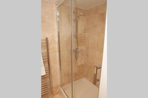 a shower stall with a glass door in a bathroom at Spectacular views, 1 Bed Central Bath Apartment in Bath