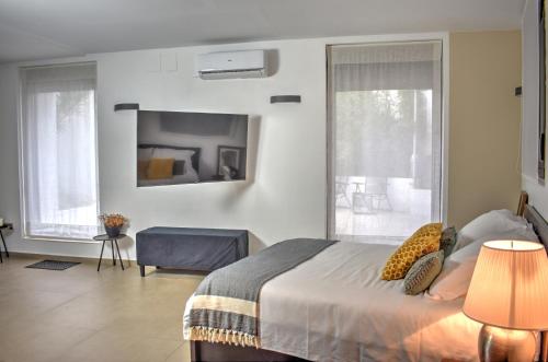 a bedroom with a bed and a large window at Home Apartments Jerez in Jerez de la Frontera