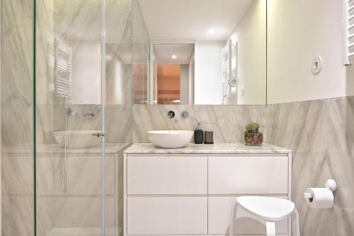 a white bathroom with a sink and a shower at Liiiving in Porto - Santa Catarina Boutique in Porto