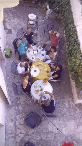 a group of people sitting at a table eating food at Alla dimora di Chiara Suite and Rooms in Matera